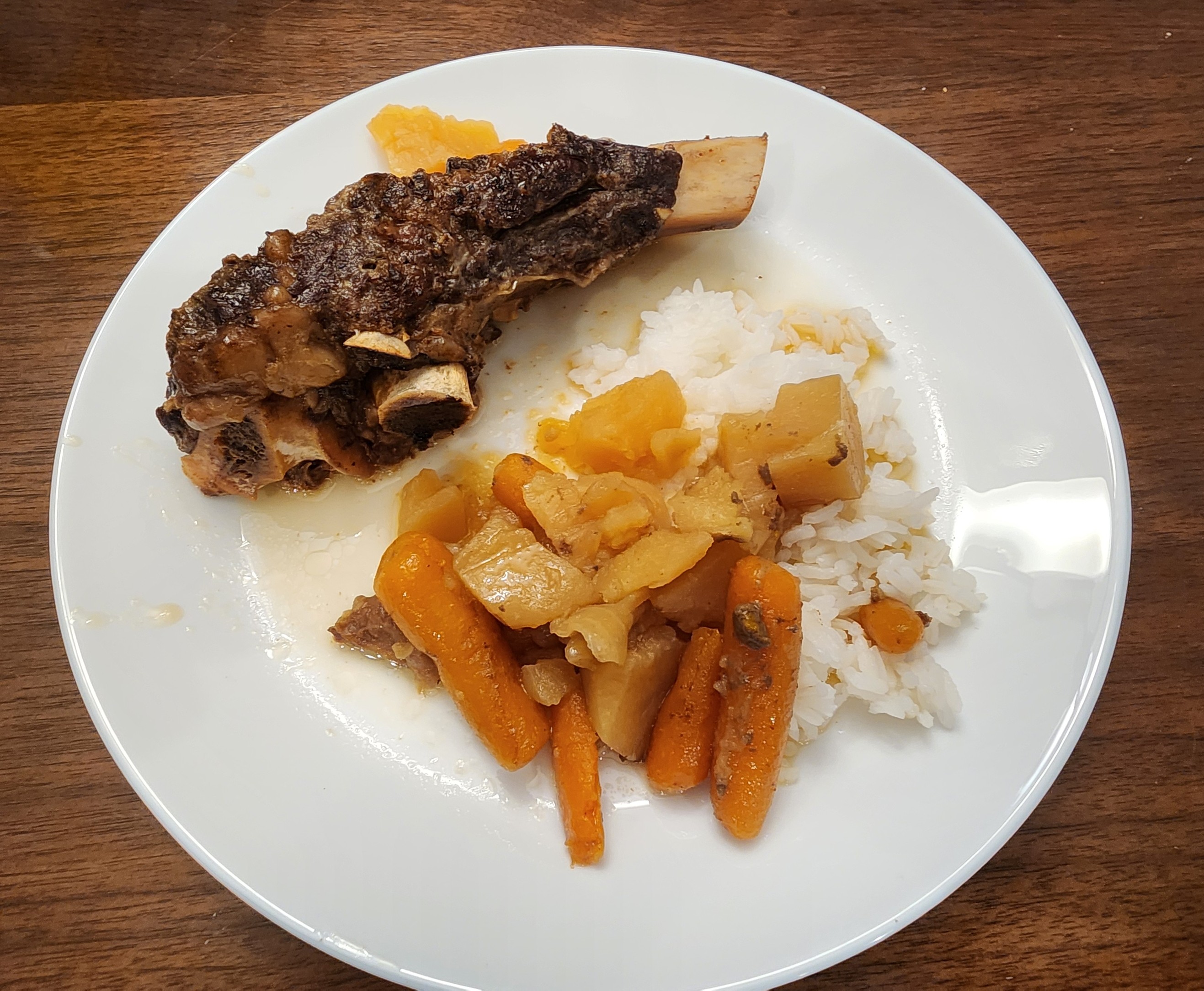 Final plated meal with beef short ribs, rice, and vegetables