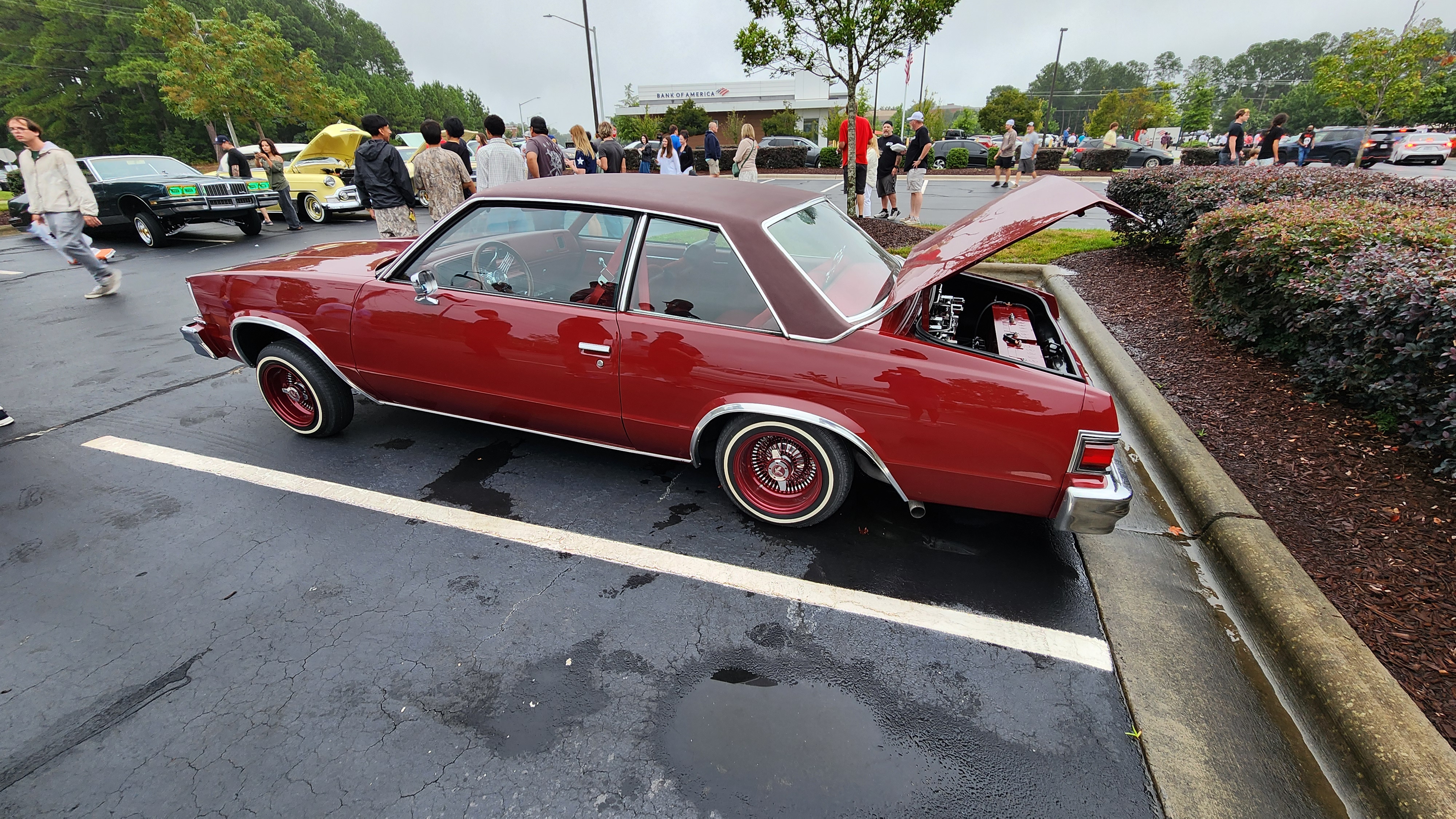 Burgundy lowrider with custom wire wheels