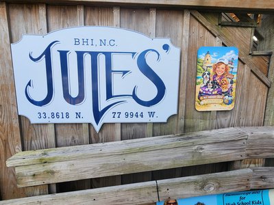 Classic nautical wooden sign for Jules' Salty Siren restaurant at Bald Head Island marina.