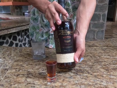 Sampling Ron Zacapa Centenario Solera Gran Reserva rum at the Baldi swim-up bar counter.