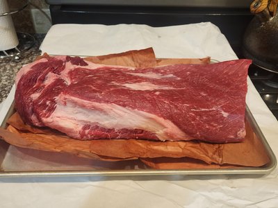 Fresh trimmed 10-pound whole brisket on a baking sheet before adding rub.