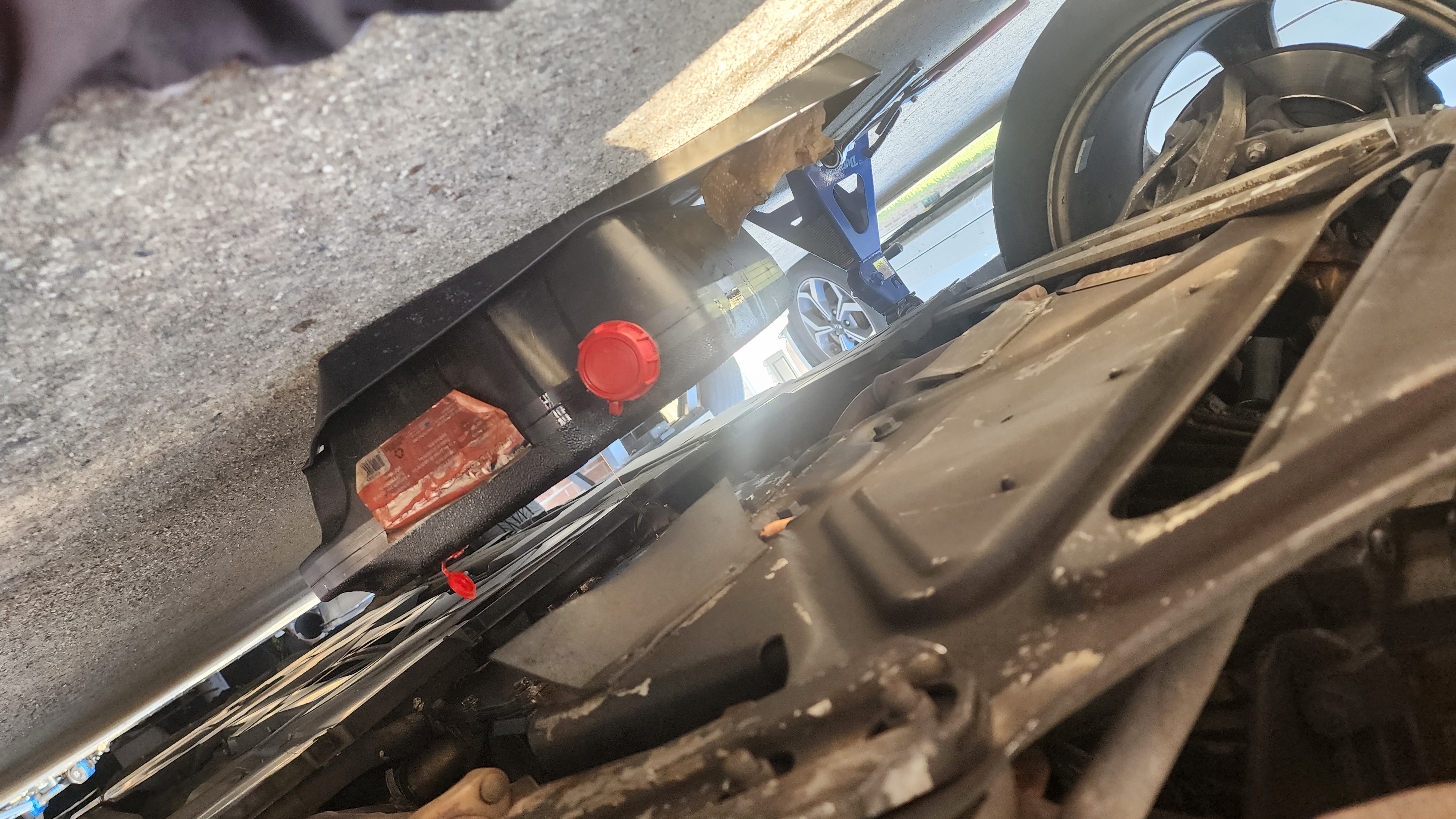 Porsche Boxster on jacks with drain pan in place